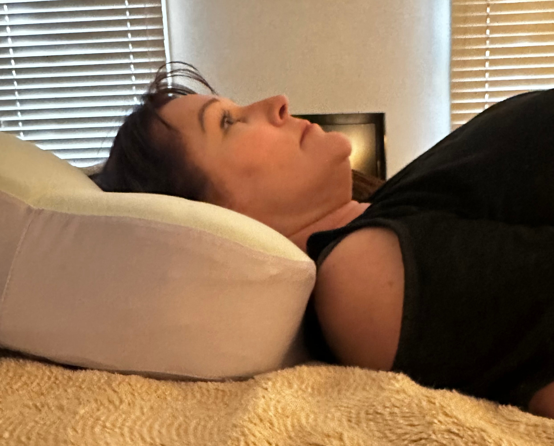 A flat pillow letting the head drop low