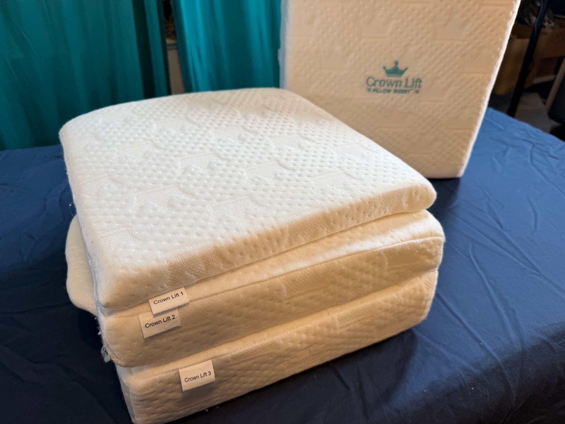 Crown Lift support cores 1, 2 and 3 stacked and labelled, with the pocket pillowcase behind them.